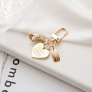 Fashion Elegant Heart Shaped <b>Shell</b> Imitation Pearl Keychain Metal Bag Pendant Gold Letter Jewelry Earphone Gift for Women - Product Image 4