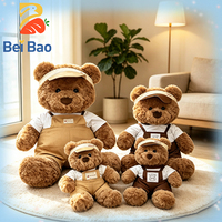 Ours en peluche marron mignon de 23 cm avec tenue de travail, personnalisable avec logo OEM, fourni par l'usine, idéal pour les boutiques
