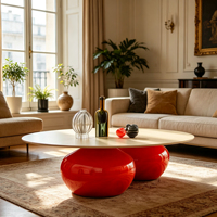Table basse ovale en fibre de verre avec plateau crème mat et base rouge brillante à double sphère pour un espace de vie moderne haut de gamme