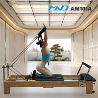 Lit de Pilates en bois d'hévéa pour entraînement de base, avec équipement de fitness MND pour entraînement quotidien en studio, destiné aux cliniques de réadaptation à Vancouver