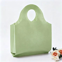 Sac fourre-tout en non-tissé épaissi avec poignée à trous ronds, sac cadeau de boutique haut de gamme, sac de rangement réutilisable pour exposition, vente en gros
