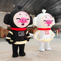 Costume de mascotte cochon noir et blanc gonflable personnalisé pour événements publicitaires, avec ventilateur intégré