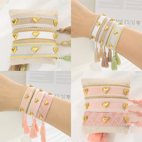 Bracelet d'amitié tissé fait main avec logo personnalisé, à clous et pompon, réglable, en corde de tissu style bohème, vente en gros, OEM usine