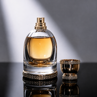 Flacons de parfum ronds en verre de luxe avec couvercle rond transparent doré 100 ml avec tête de pulvérisation à pompe avec boîte d'emballage