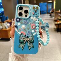 Coque de téléphone de luxe créative en élastomère thermoplastique, motif nœud floral, ornée de diamants et de perles, avec sangle chaîne pulvérisée
