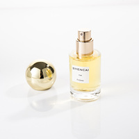 Flacon de parfum en verre transparent cylindrique de 15 ml, format voyage, avec vaporisateur et capuchon rond, pour parfum de luxe.