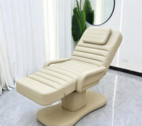 Lit de massage électrique réglable avec accoudoirs en velours noir et piédestal doré pour spa et clinique de beauté
