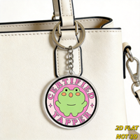 Portachiavi Certificato Yapper Frog, simpatico rospo verde su cerchio rosa, accessorio divertente per amanti dei chat, per borse, chiavi, zaini