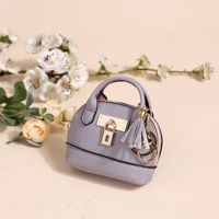 Porte-monnaie ovale mini en cuir de luxe écologique, mignon, avec porte-clés, cadeau de haute qualité pour voiture, vente chaude en gros
