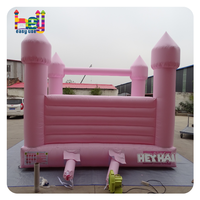 Château gonflable rose pâle macaron pour enfants et adultes, idéal pour la location lors de mariages et fêtes