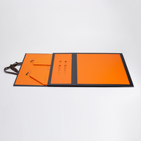 Boîte cadeau magnétique pliable de luxe avec design orange et noir et poignée