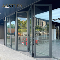 Porte pliante en aluminium AOSTTER à cadre noir robuste avec double vitrage isolant et verrouillage multipoints pour une utilisation haut de gamme dans les salles à manger