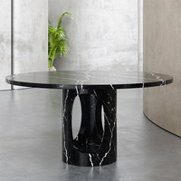 Table de salle à manger ronde en marbre avec base découpée en ellipse, sculptée à la main en pierre massive, pour un intérieur de maison haut de gamme