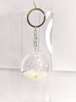 Fabricant OEM ODM, Vente en gros : Porte-clés mini donut créatif et original, avec paillettes, sequins et flotteur aquatique à sable mouvant, idéal comme souvenir, cadeau ou jouet