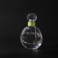 Logo personnalisé de gros 50ml oblate atomiseur vaporisateur de parfum en verre avec bouchon à bille ronde avec processus d'enroulement vert Surlyn