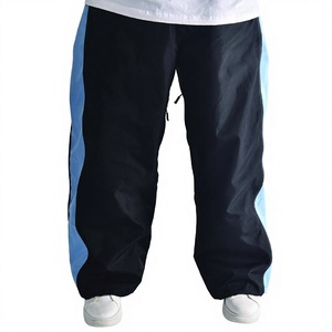 Pantalon chauffant unisexe noir imprimé avec empiècements zippés bleus dissimulés, taille ajustable avec cordon de serrage, ourlet élastique, style Techwear coupe ample - Product Image 1