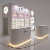 Kiosque cosmétique personnalisé avec éclairage LED, comptoir de réception incurvé, niche en arc, vitrine pour produits de soin de la peau et de parfumerie pour boutique de beauté