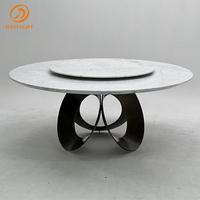 Table à manger de luxe au design moderne avec plateau en céramique en pierre frittée et base ronde en acier noir thermolaqué pour mobilier de salle à manger
