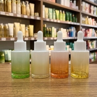 Flacon compte-gouttes cylindrique en verre vert de luxe 20ml 30ml 50ml pour sérum cosmétique avec impression de logo