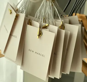 Borsa di carta bianca biodegradabile per acquisti con manico pieghevole portatile di lusso negozio di vestiti al dettaglio confezione regalo porta sacchetti di carta