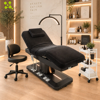 Lit de massage électrique haut de gamme avec design incurvé, éclairage LED, chauffage et modes de contrôle doubles pour salon de beauté et spa facial