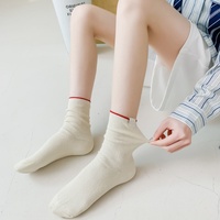 Vente en gros de chaussettes mi-mollet côtelées pour femmes, couleur unie, douces, respirantes, en coton, chaussettes décontractées