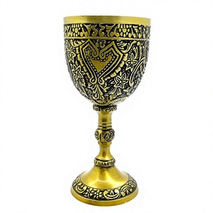 Calice artisanal doré avec emblème cœur audacieux, surface gravée florale et détails contrastants noirs – Coupe élégante sur pied décorative - Product Image 1