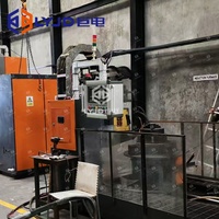 Machine de traitement thermique par induction pour le durcissement et le trempage, avec système de chargement et de déchargement pour arbres/disques