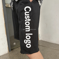 Shorts en molleton de coton noir à ourlet brut, coupe ample, avec logo brodé personnalisé OEM ODM, taille élastique, pour hommes