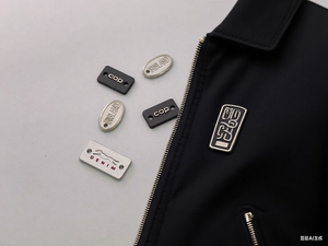 ป้ายโลหะสลักลายนูนโลโก้แบรนด์แบบกำหนดเอง เป็นมิตรกับสิ่งแวดล้อม ขายดี สำหรับชุดว่ายน้ำ ผ้าพันคอ ชุดชั้นใน เสื้อผ้า - Product Image 2