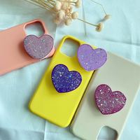 Vente chaude support universel de poignée de doigt de téléphone nouveaux accessoires en forme de coeur de puissance de paillettes en matériau PC Durable