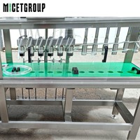Machine de remplissage semi-automatique MICET pour bouteilles en verre avec bouchons couronne, 6 stations de remplissage et 6 stations de capsulage avec réservoir de stockage, à vendre