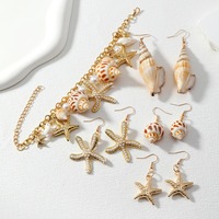 Collier, bracelet et boucles d'oreilles unisexes plaqués or, style bohème chic, avec breloques en forme de coquillage, étoile de mer et conque, pour la vente en gros