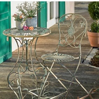 Ensemble table et chaises rondes en fer forgé de style campagnard français vintage, vert foncé vieilli, pour patio et jardin extérieur