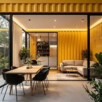 Maison en conteneur d'acier à deux étages, style cabane Apple, avec grandes fenêtres en verre jaunes, entièrement meublée, idéale pour séjour familial dans le jardin.