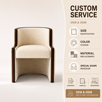 Fauteuil lounge moderne avec dossier incurvé enveloppant, fauteuil en tissu avec finition en bois pour coin lecture dans le salon