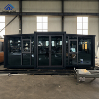 Tamamen Siyah Camlı Ön Cepheli Genişletilebilir Konteyner Ev, Tavandan Tabana Pencereler, Modern Balıksırtı Döşeme, Prefabrik Stüdyo, Depo Kullanımı