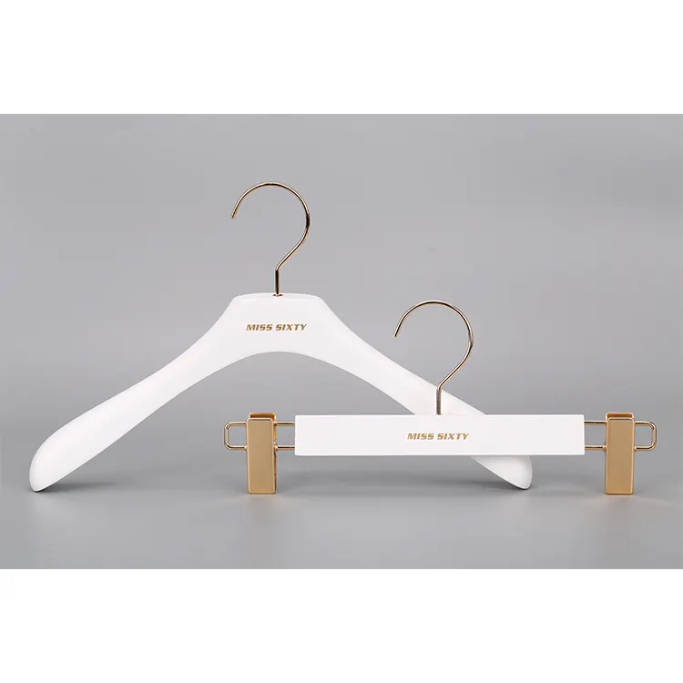 clothes shop display white clothes wooden hanger with gold hook