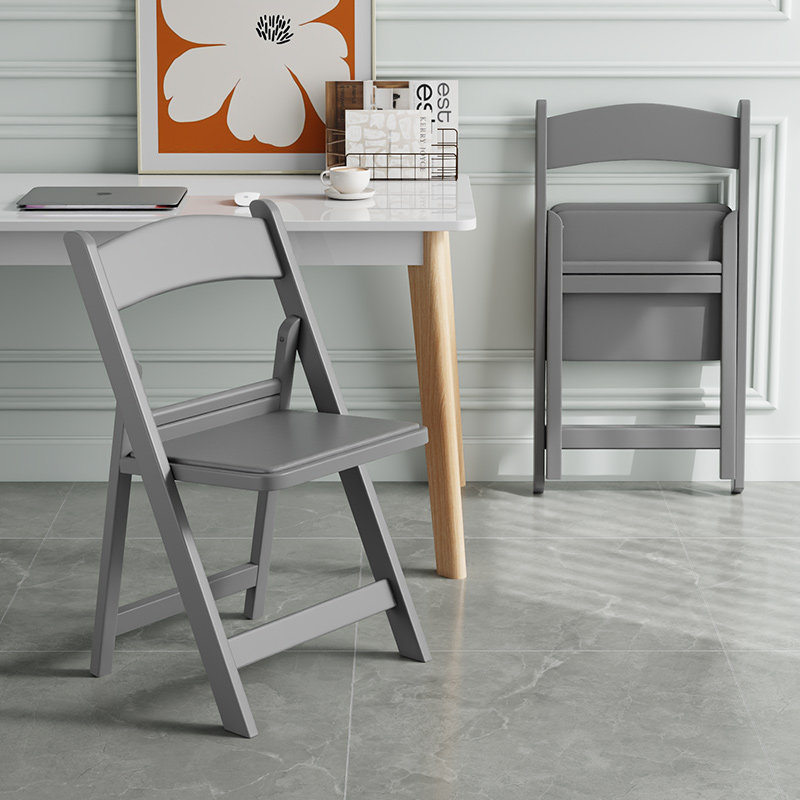 Gray upholstered folding chair with reinforced seat