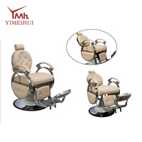 Fauteuil de barbier inclinable robuste de style rétro, en cuir capitonné beige, avec structure en métal poli, rotation à 360°
