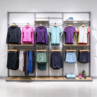 Porte-vêtements robuste en métal gris avec panneau grillagé, barre de suspension, roulettes et étagères, autoportant, CE ETL, vente en gros pour boutiques