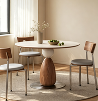 Table à manger ronde nordique compacte avec plateau en pierre frittée et piétement unique en bois de noyer pour appartement