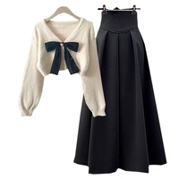 Ensemble pull et jupe taille haute décontracté pour femme, style automne, avec nœud, manches bouffantes, col en V, boutonnage simple, couleur unie, 100 % polyester, vente en gros