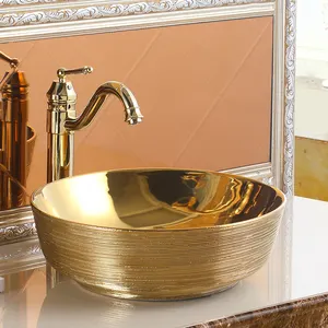 ゴールデンホテル装飾高級洗面台セラミックラウンドテーブルカウンタートップブラッシュドゴールドカラーバスルームシンクフェイス手洗い洗面台