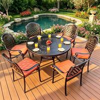 Ensemble de salle à manger d'extérieur en aluminium moulé, table ronde sculptée et chaises empilables, mobilier de jardin imperméable pour villa et cour
