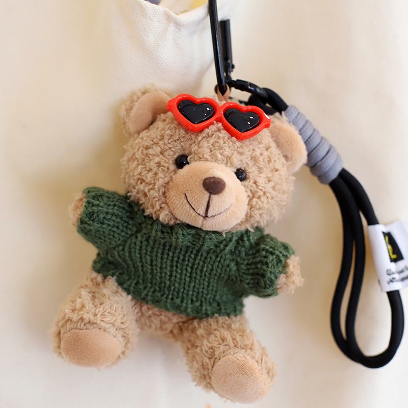 Green sweater light brown bear hand rope