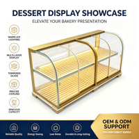 Vitrine de boulangerie de luxe haut de gamme avec cadre en métal doré, verre incurvé, éclairage LED, durable et multifonctionnelle, comptoir de vente au détail