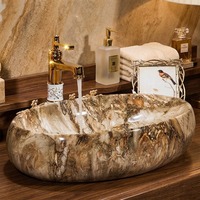 Lavabo ovale en céramique à texture marbre naturel de luxe, lavabo artistique à poser sur comptoir pour projets hôteliers et villas haut de gamme