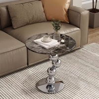 Table basse moderne en pierre frittée avec structure en acier inoxydable argenté – Design durable, écologique et pratique pour votre salon