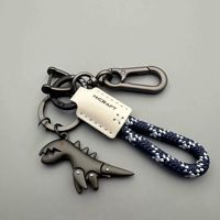 Porte-clés dinosaure T-Rex en alliage de zinc personnalisé avec cordon tressé pour voiture, sac à dos, sac à main, cadeau, vente en gros